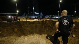 A view of a giant hole as Israeli forces arrive in the area and investigate debris of missiles fired from Iran towards Israel, after they fall in Herzliya, north of Tel Aviv, Israel, Oct. 1, 2024. (Saeed Qaq/Anadolu via Getty Images)