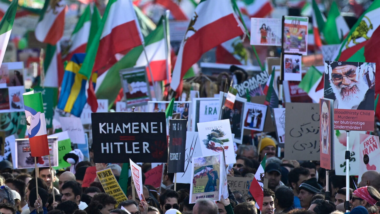 Protesters hold up a placard reading "Khamenei is Hitler" in a rally in Berlin, Germany on Oct. 22, 2022.