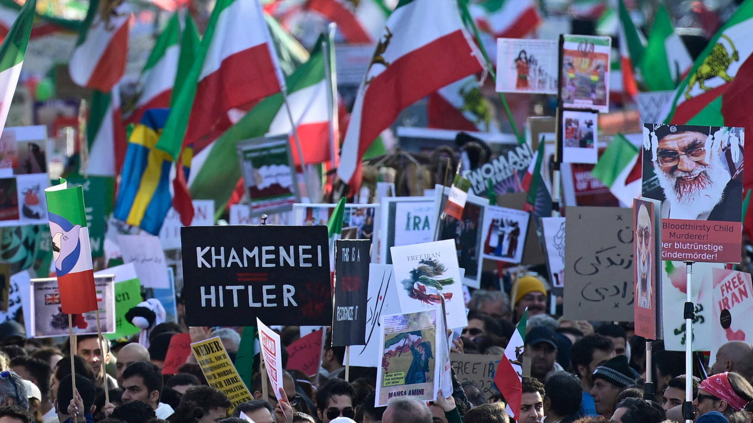 Protesters hold up a placard reading "Khamenei is Hitler" in a rally in Berlin, Germany on Oct. 22, 2022.