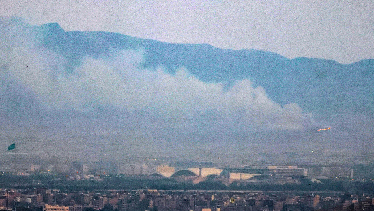 Smoke and fire billow from the site of an alleged Israeli strike in southern Tehran on June 13.