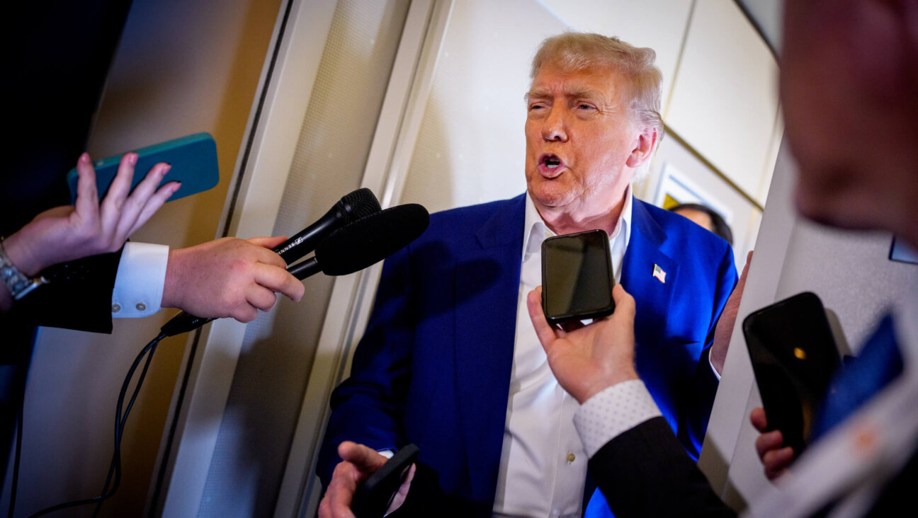 President Donald Trump speaks to members of the media aboard Air Force One on the way to the 2025 NATO Summit on June 24.
