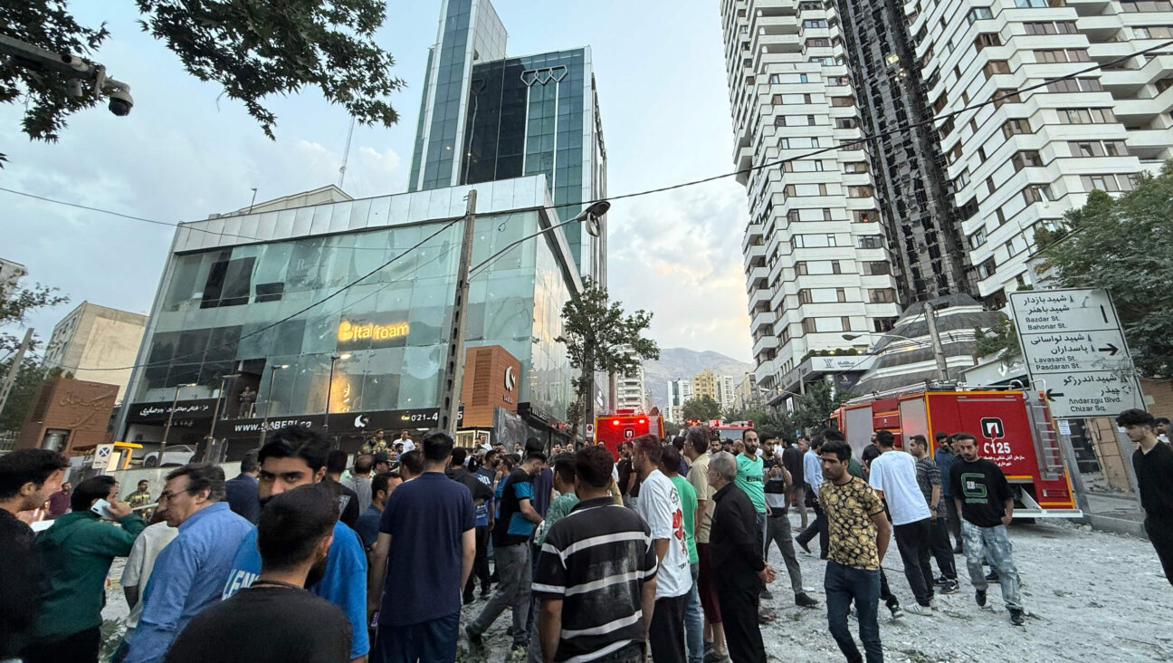 People look over the aftermath of a massive Israeli airstrike on June 13  in Tehran, Iran. 
