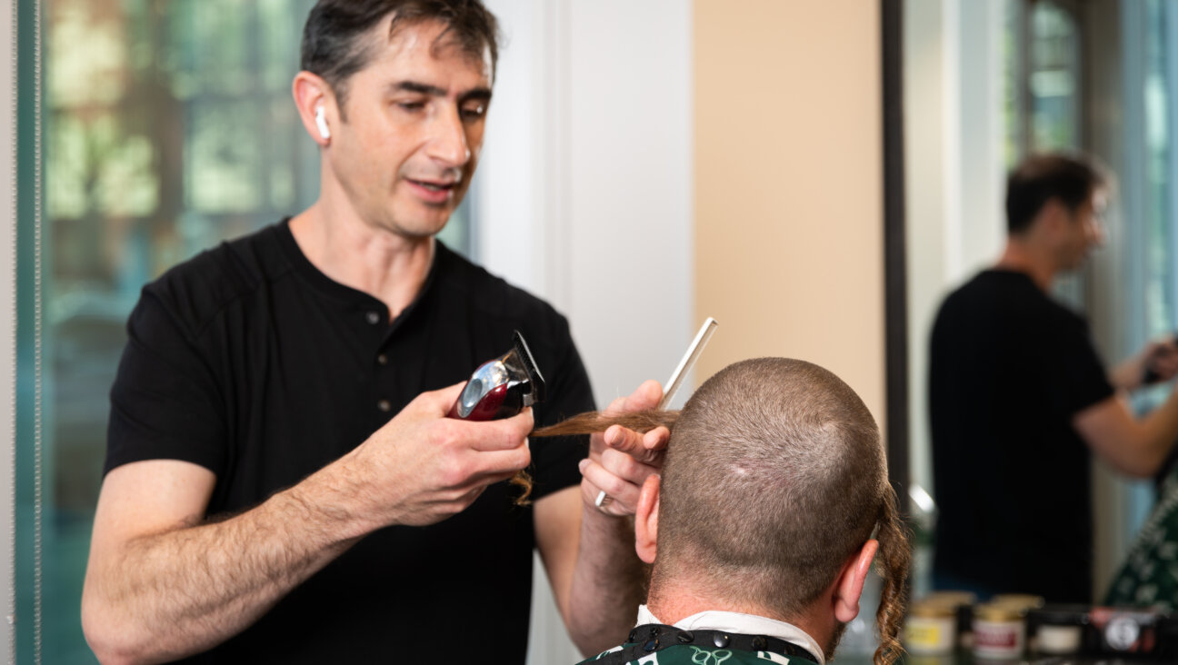 At Kent Avenue Barber Shop, Gabi Zav attends to a customer.