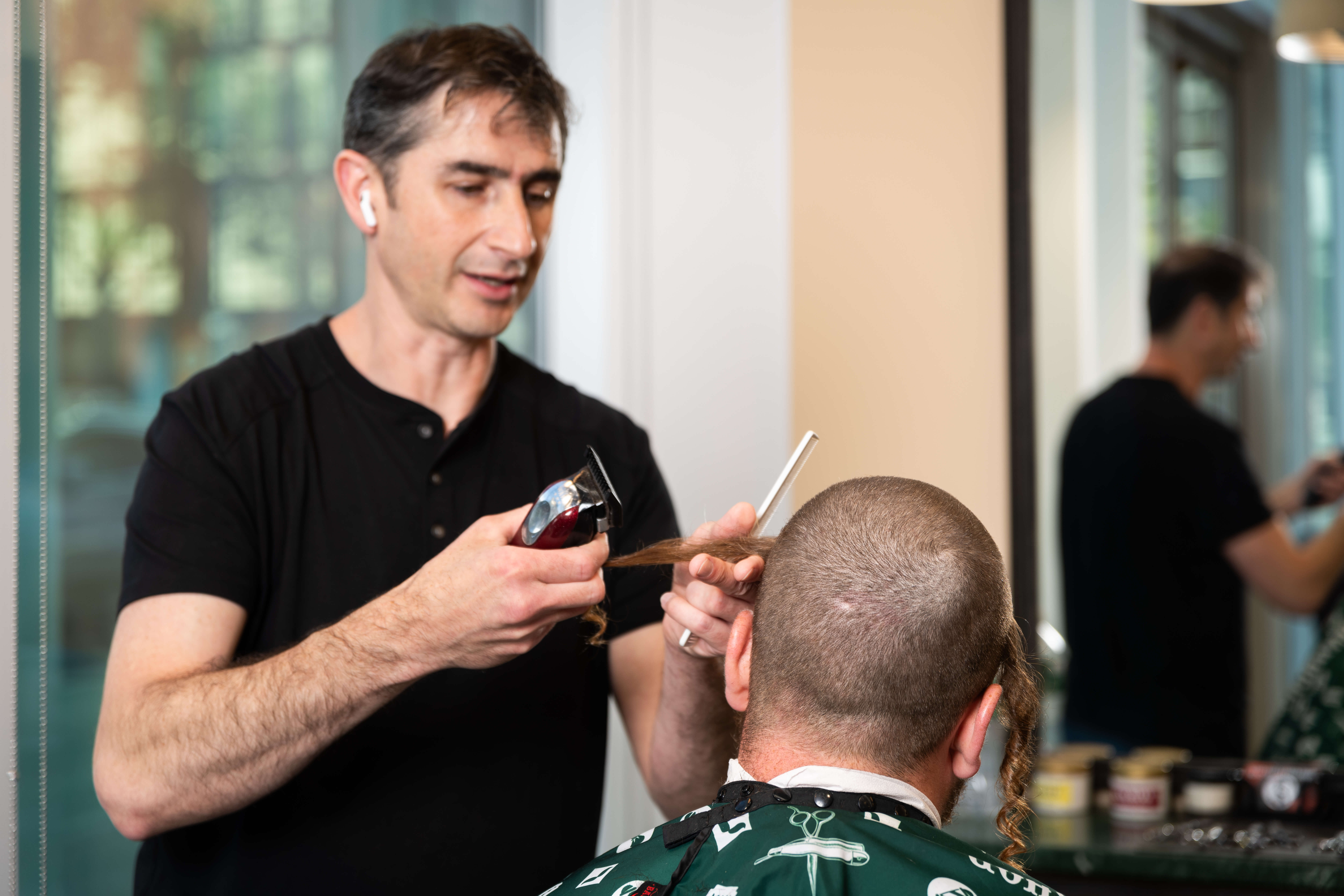 At Kent Avenue Barber Shop, Gabi Zav attends to a customer.