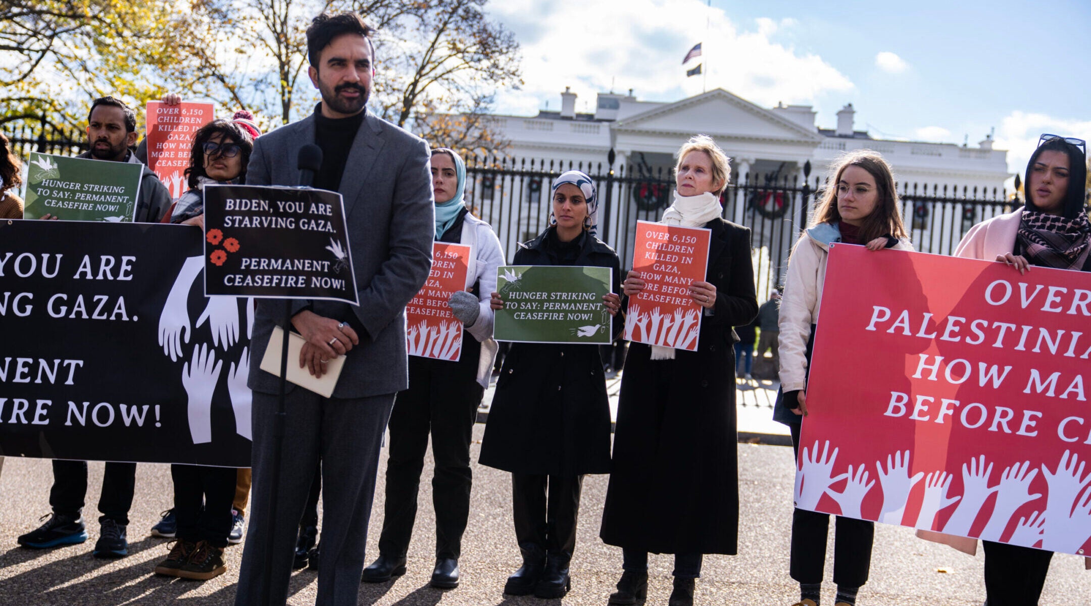 Actor and activist Cynthia Nixon, third from right, listens to New York State Rep. Zohran Mamdani (D), speak during a news conference outside the White House to announce a hunger strike to demand that President Joe Biden “call for a permanent ceasefire and no military aid to Israel,” on Nov. 27, 2023. (Tom Williams/CQ-Roll Call, Inc via Getty Images)