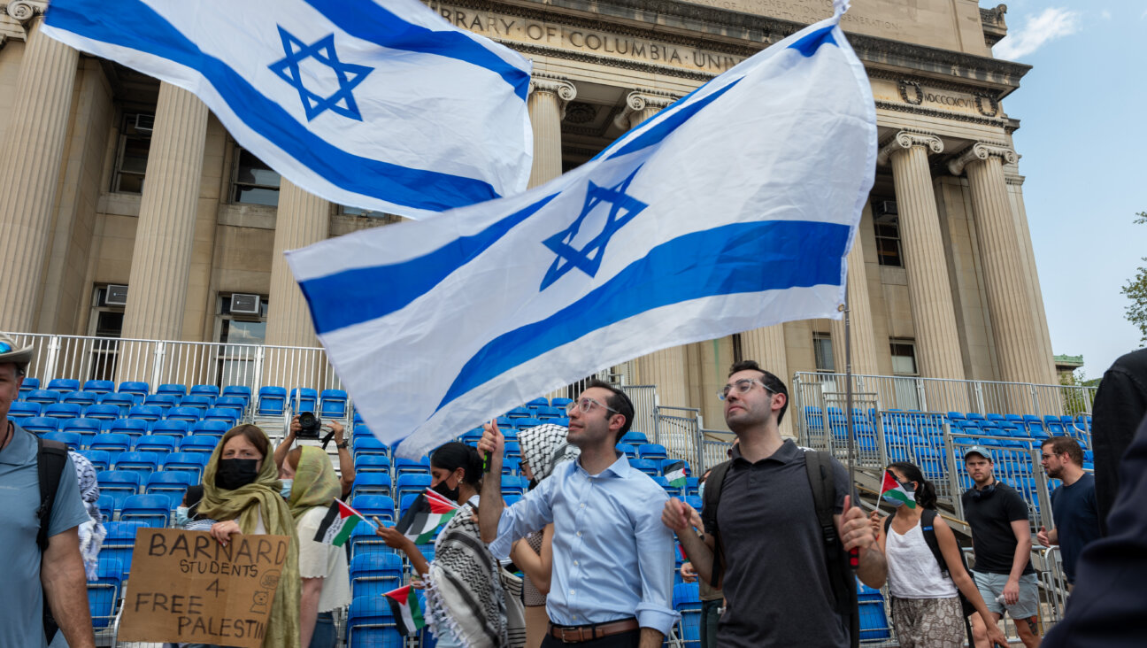 Men wave an Israeli flag as pro-Palestinian supporters continue to demonstrate from a protest encampment on the campus of Columbia University on April 29, 2024.