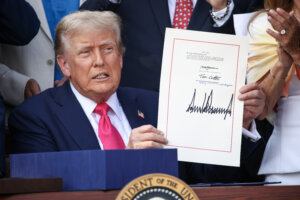 President Donald Trump signs the One Big Beautiful Bill Act into law on July 4.