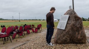 A man reads one of the plaques newly placed near a Polish monument to the wartime Jedwabne massacre of Jews by their Polish neighbors, July 10, 2025. The plaques question the official findings and claim that “the crime was committed by a German pacification unit” instead of local Poles. 