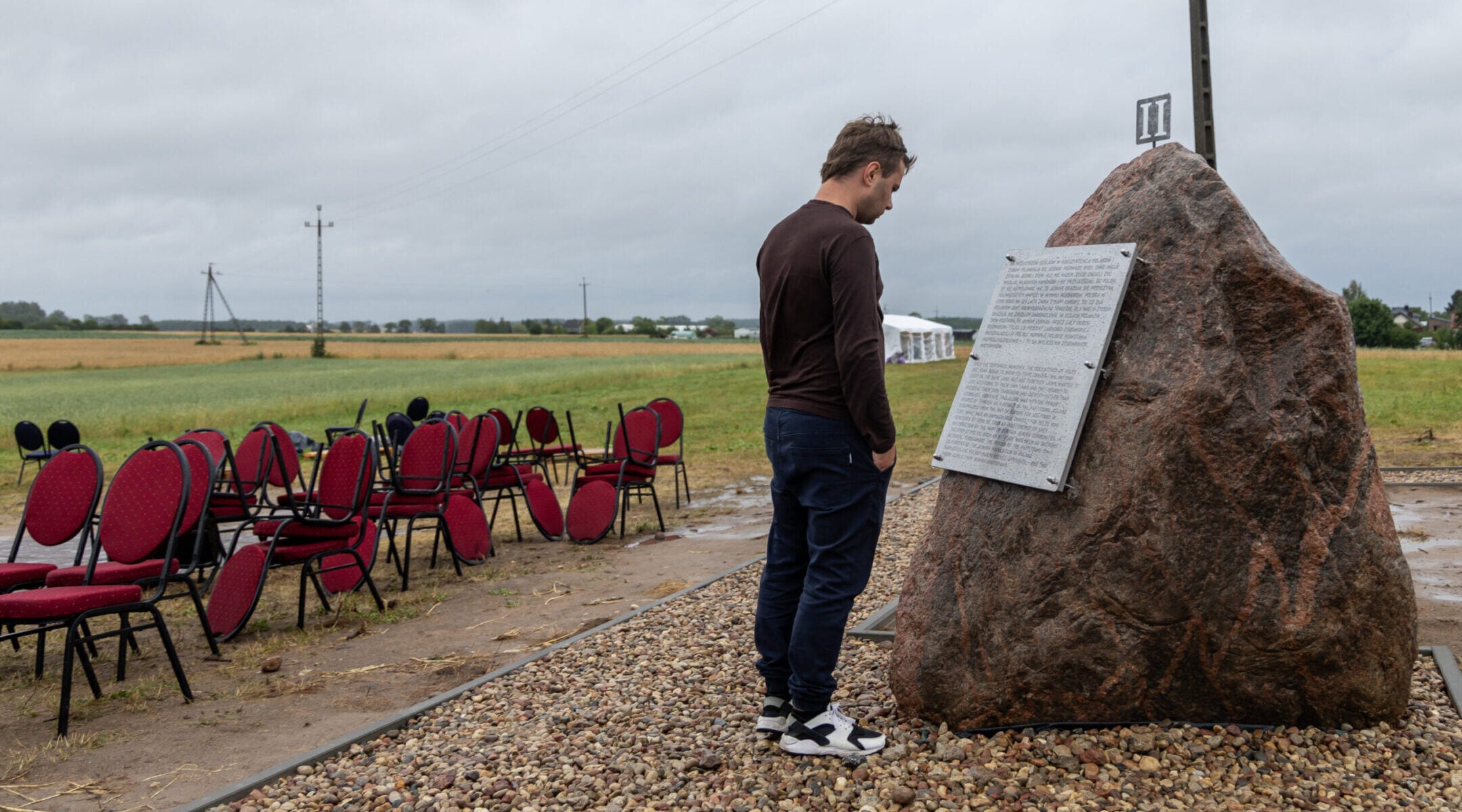A man reads one of the plaques newly placed near a Polish monument to the wartime Jedwabne massacre of Jews by their Polish neighbors, July 10, 2025. The plaques question the official findings and claim that “the crime was committed by a German pacification unit” instead of local Poles. 