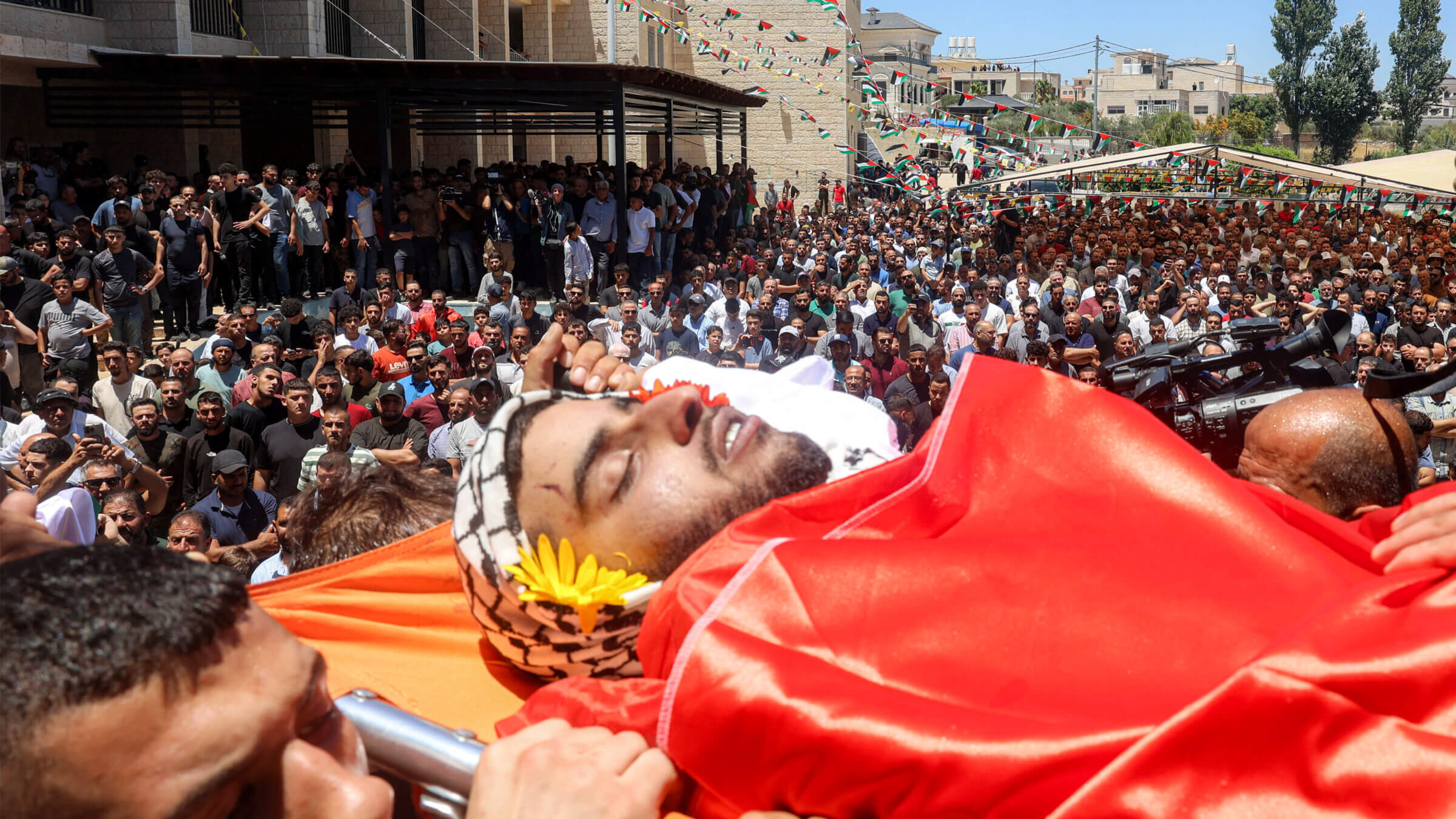 Mourners carry the body of dual U.S.-Palestinian citizen Saif Musalat during his funeral in the Palestinian village of Al-Mazraa Al-Sharqiya in the West Bank on July 13, after he was reportedly killed by Israeli settlers two days prior. 