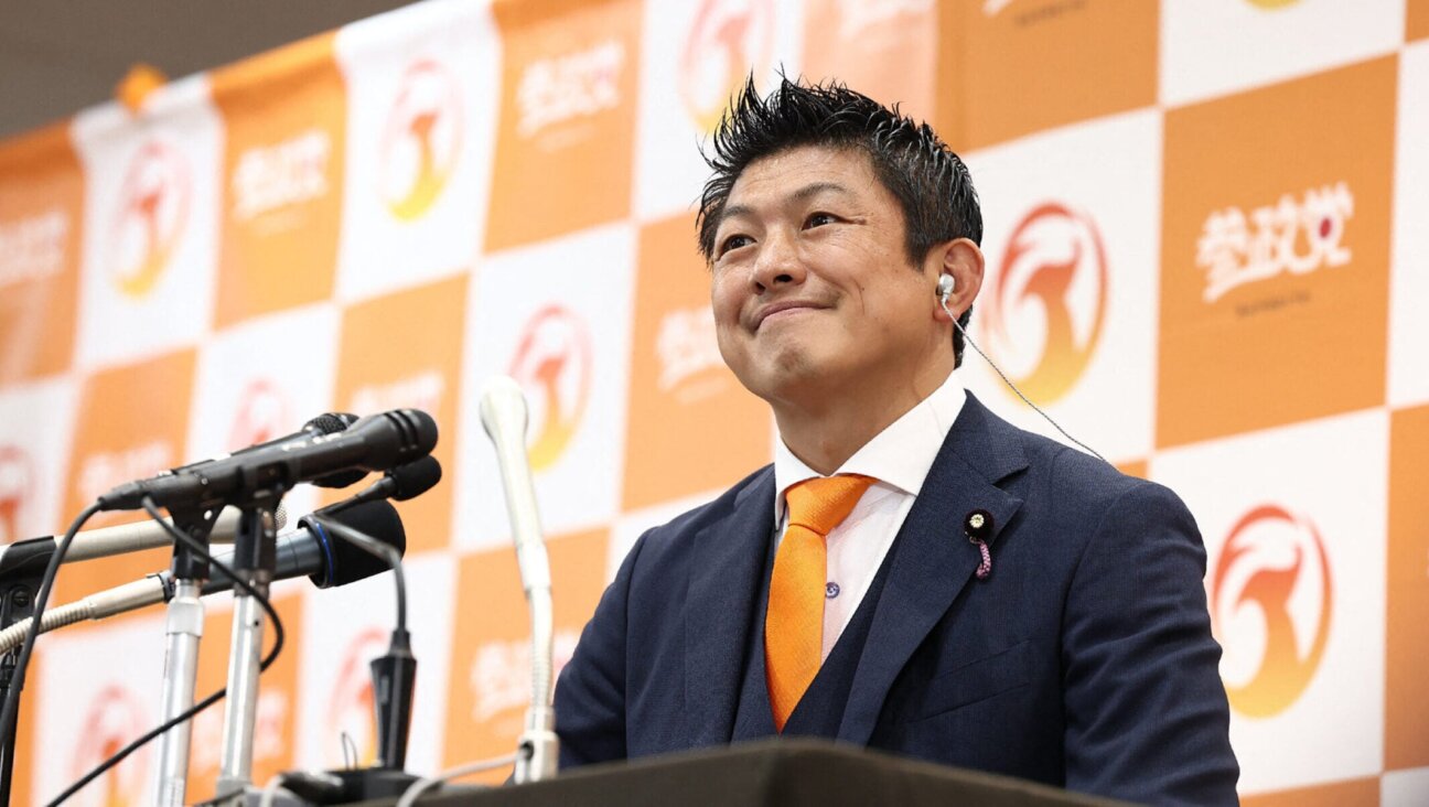 Japan’s opposition party Sanseito leader Sohei Kamiya smiles as he speaks to members of the media at the vote counting center in Tokyo on July 20, 2025. 