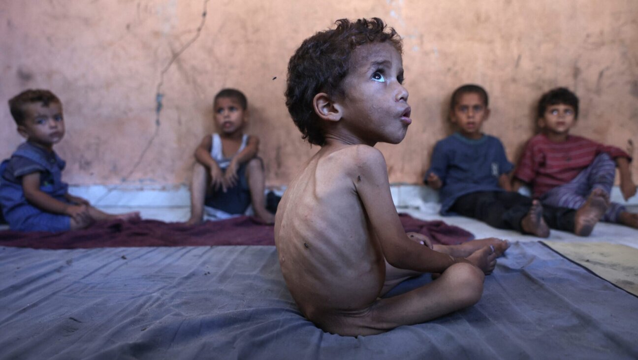 Yazan, a malnourished 2-year-old Palestinian boy, sit with his brothers at their family’s damaged home in the Al-Shati refugee camp, west of Gaza City, on July 23, 2025. 