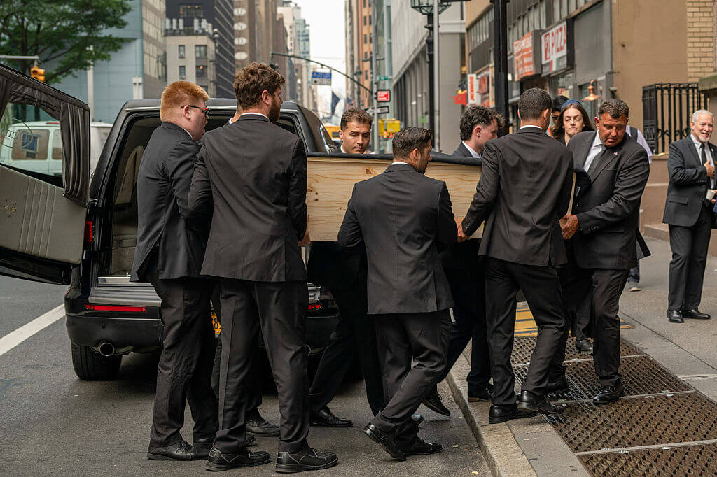 Pall bearers carry the casket of Wesley LePatner, who was killed in Monday's shooting at 345 Park Avenue, into Central Synagogue ahead of a funeral service on Thursday. 