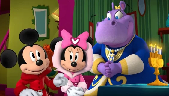 A still from the episode “Nochebuena at the Funhouse / Hanukkah at Hilda’s. Hilda's hands are covering the ichthys, commonly known as a Jesus fish.
