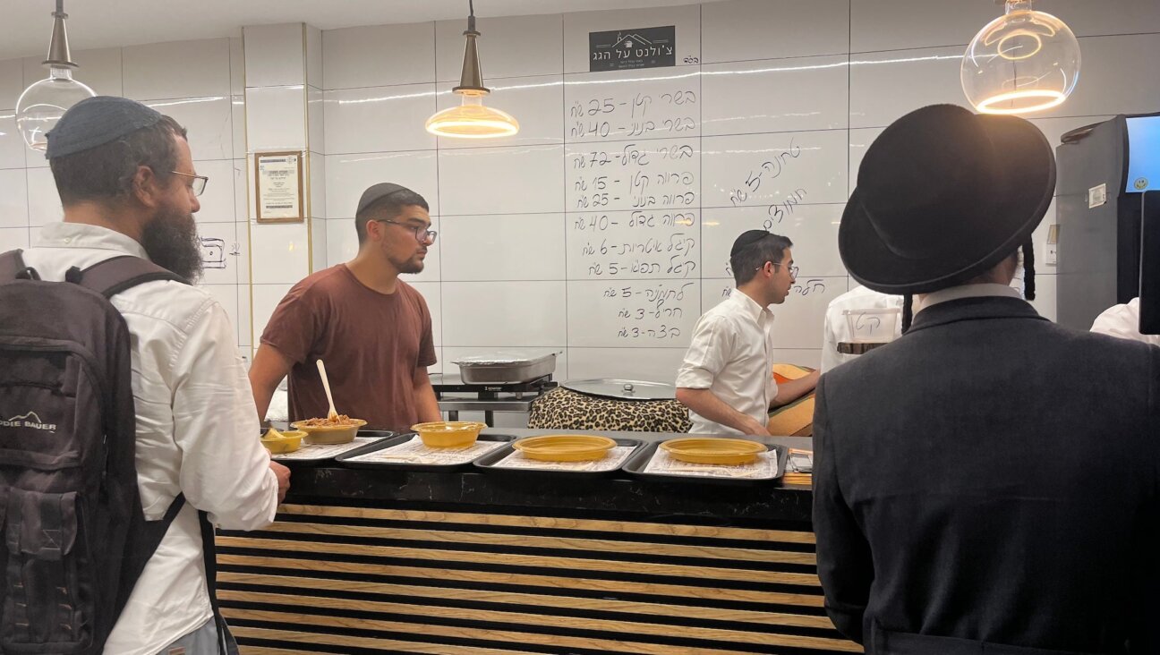 A diner buys cholent at Cholent on the Roof in Geula, Jerusalem, on July 10, 2025.