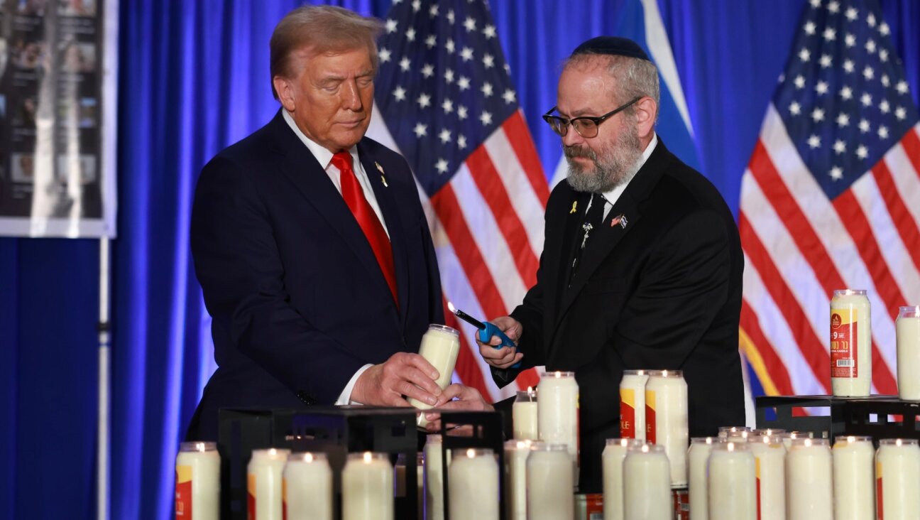 Donald Trump and Yehuda Kaploun light a candle during an Oct. 7 remembrance event at the Trump National Doral Golf Club in Doral, Florida on Oct. 07, 2024. (Joe Raedle/Getty Images)