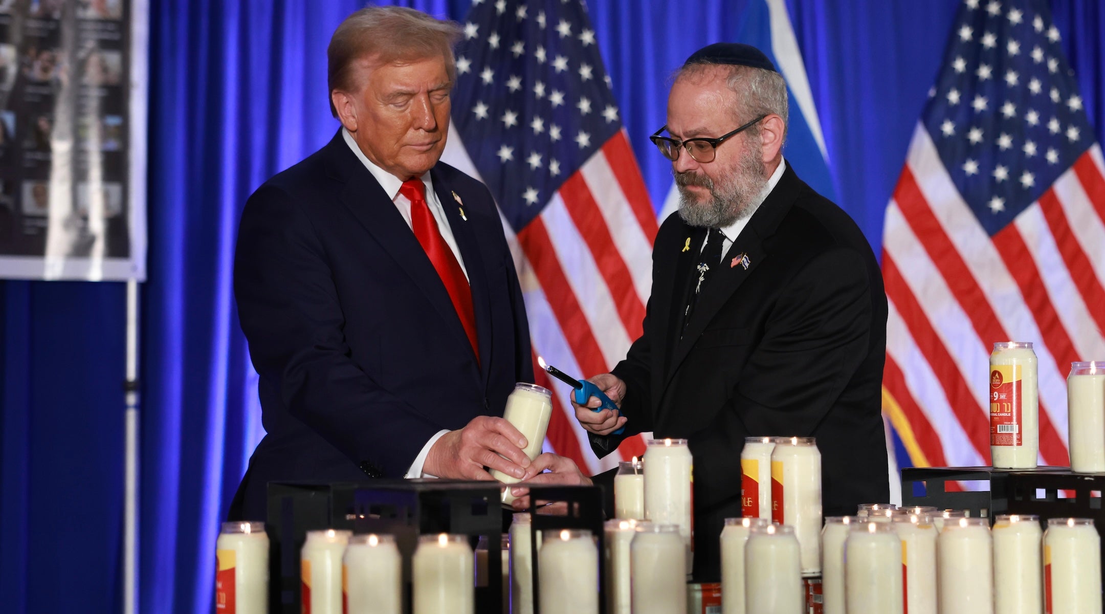 Donald Trump and Yehuda Kaploun light a candle during an Oct. 7 remembrance event at the Trump National Doral Golf Club in Doral, Florida on Oct. 07, 2024. (Joe Raedle/Getty Images)