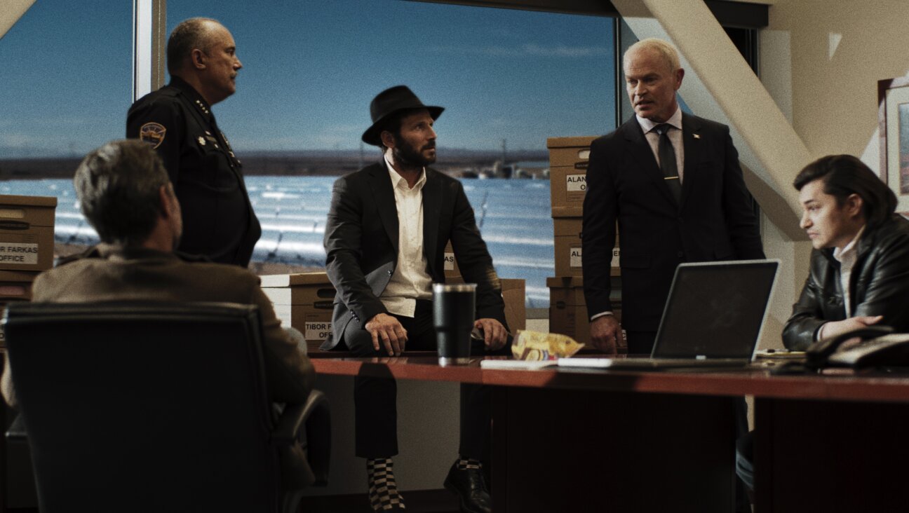 Mark Feuerstein plays Rabbi Mo Zaltzman (center), a small town Rabbi who has to unravel a complex conspiracy.