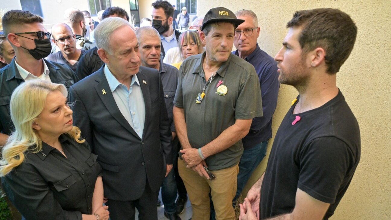 Israeli Prime Minister Benjamin Netanyahu speaks with American-Israeli released hostage Sagui Dekel-Chen during his visit to Kibbutz Nir Oz on July 3, 2025. (Photo by Kobi Gideon/GPO)