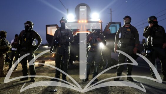Officers gathered in paramilitary gear before a mass deportation effort in California.