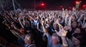 Fans of Croatian nationalist singer Marko Perkovic Thompson gather at the Zagreb hippodrome during a concert by the singer, who is known for his sympathies for the country’s World War II Nazi-allied regime, to an expected by a crowd of some 450,000 people, in Zagreb, on July 5, 2025. (DAMIR SENCAR / AFP)
