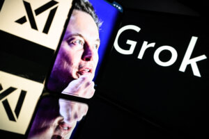 Screens displaying the logo of Grok, a generative artificial intelligence chatbot developed by xAI, and the image of its founder, Elon Musk.