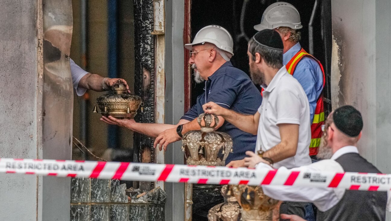 Congregants recover items from the Adass Israel Synagogue on December 06, 2024 in Melbourne, Australia.