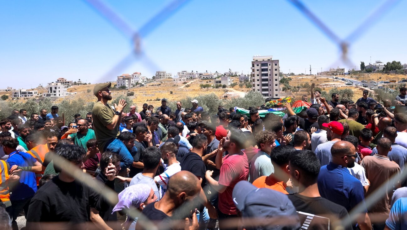 Mourners carry the bodies of Mohammad al-Shalabi, 23, and Sayafollah Musallet, 20, during their funeral on July 13, 2025, in Al-Mazra’a ash-Sharqiya, east of Ramallah in the occupied West Bank. (Mohammad Nazal / Middle East Images via AFP)