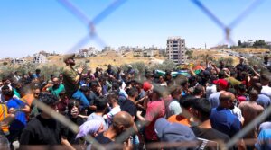 Mourners carry the bodies of Mohammad al-Shalabi, 23, and Sayafollah Musallet, 20, during their funeral on July 13, 2025, in Al-Mazra’a ash-Sharqiya, east of Ramallah in the occupied West Bank. (Mohammad Nazal / Middle East Images via AFP)