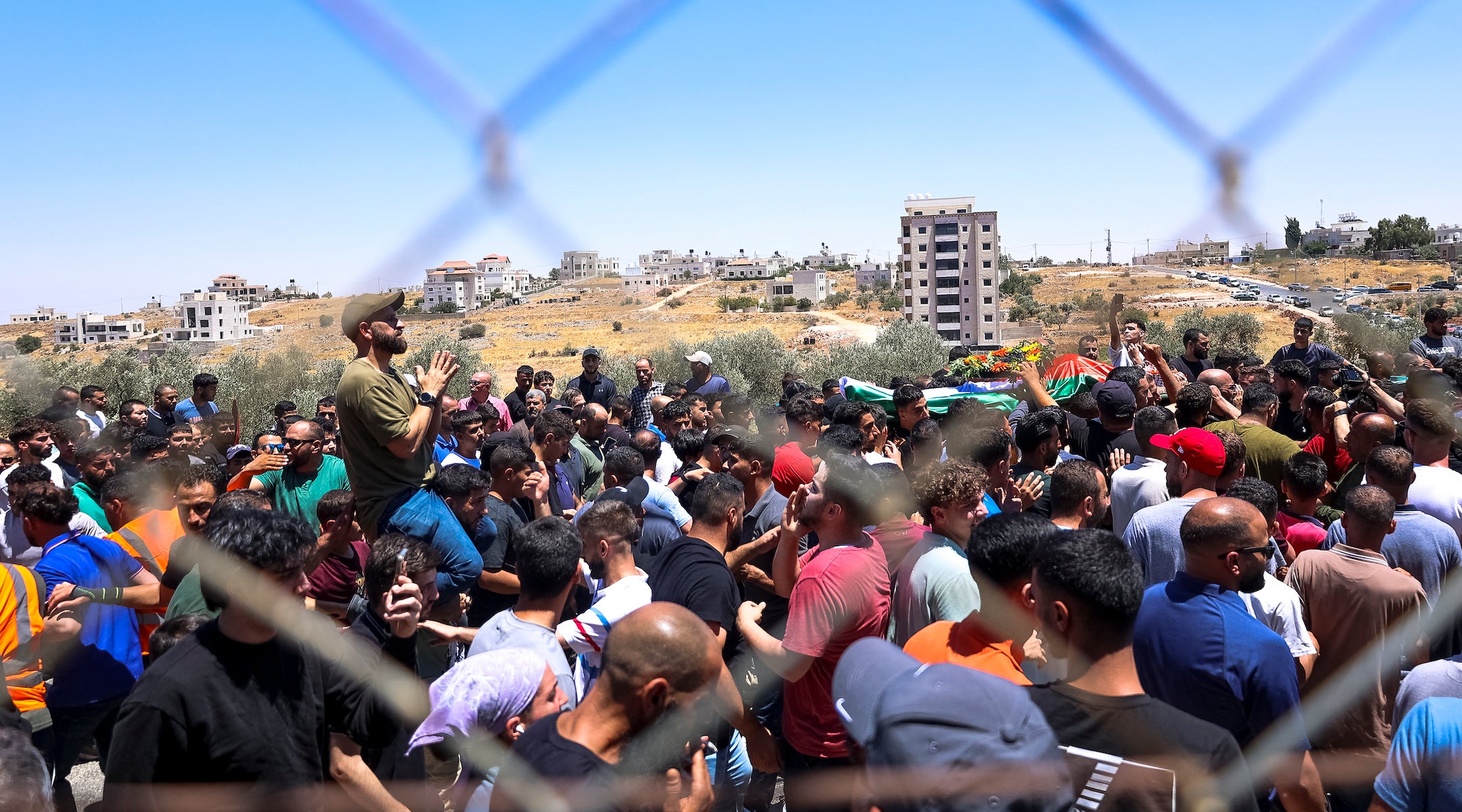 Mourners carry the bodies of Mohammad al-Shalabi, 23, and Sayafollah Musallet, 20, during their funeral on July 13, 2025, in Al-Mazra’a ash-Sharqiya, east of Ramallah in the occupied West Bank. (Mohammad Nazal / Middle East Images via AFP)