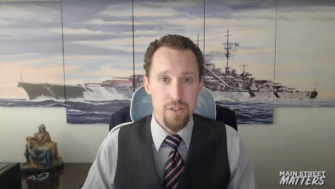 Economist E.J. Antoni is interviewed in front of art depicting the Nazi warship Bismarck, December 9, 2024. In August 2025, President Trump nominated Antoni to lead the Bureau of Labor Statistics.