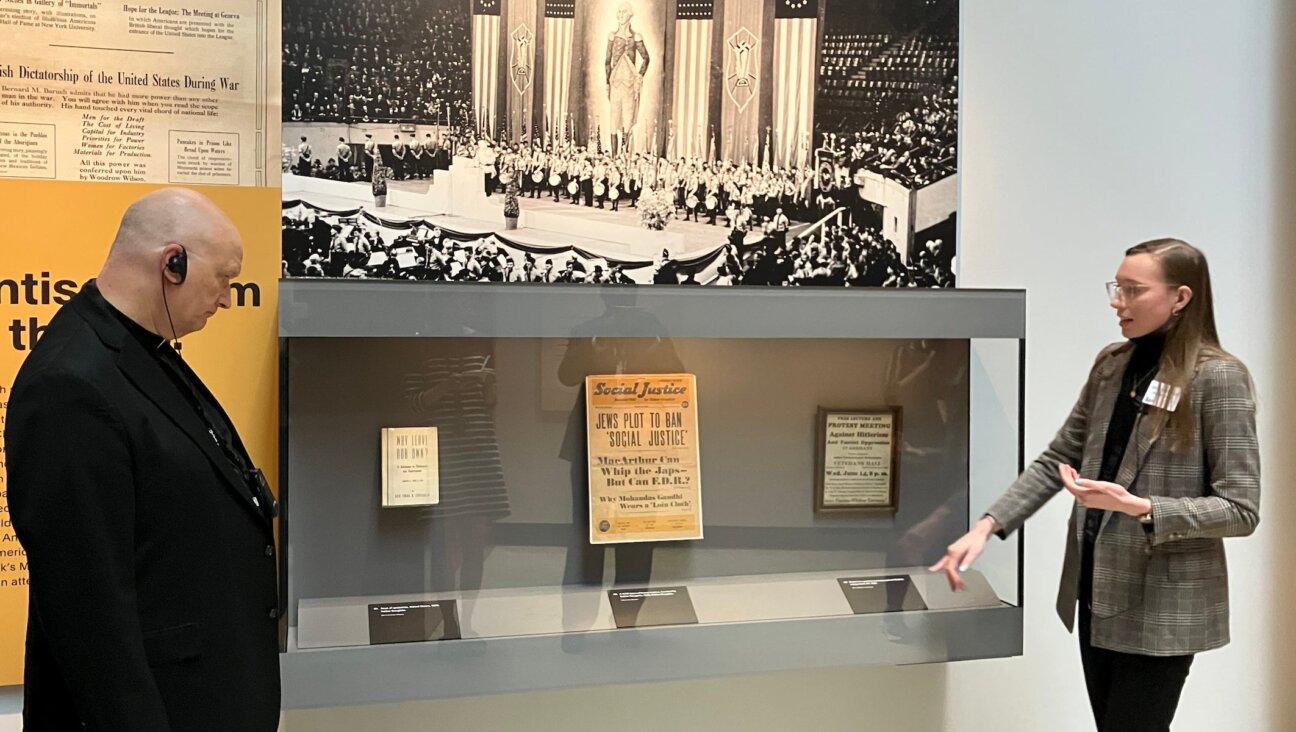 Detroit Archbishop Edward Weisenburger (left) studies an exhibit discussing Detroit-area “radio priest” Father Coughlin’s antisemitism during a tour of the Zekelman Holocaust Center in Farmington Hills, Michigan, on a tour led by museum staff Jamie Miskowski (right), who is Catholic, Aug. 18, 2025. Weisenburger has vocally advocated for civilians in Gaza amid Israel’s ongoing war in the region.