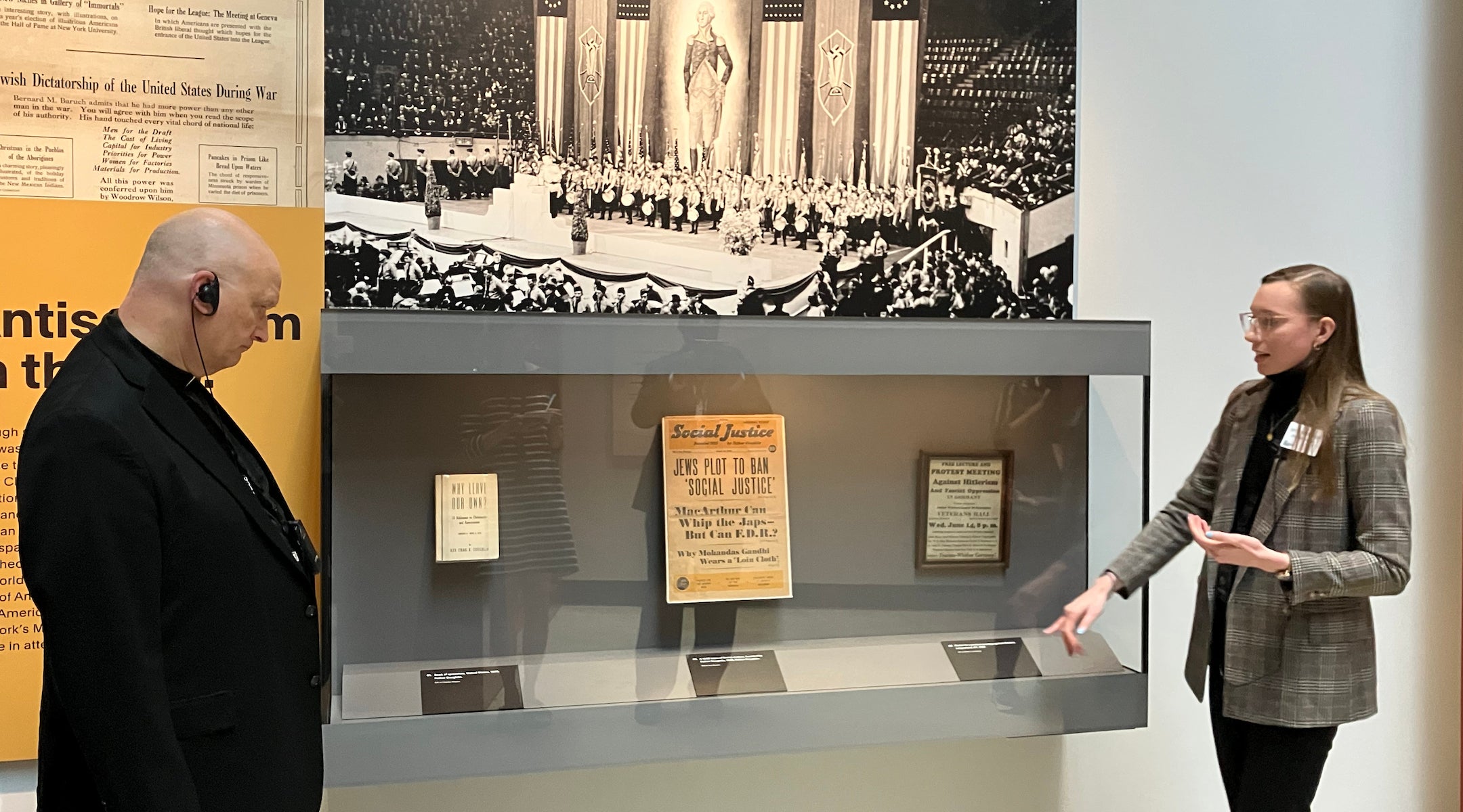 Detroit Archbishop Edward Weisenburger (left) studies an exhibit discussing Detroit-area “radio priest” Father Coughlin’s antisemitism during a tour of the Zekelman Holocaust Center in Farmington Hills, Michigan, on a tour led by museum staff Jamie Miskowski (right), who is Catholic, Aug. 18, 2025. Weisenburger has vocally advocated for civilians in Gaza amid Israel’s ongoing war in the region.
