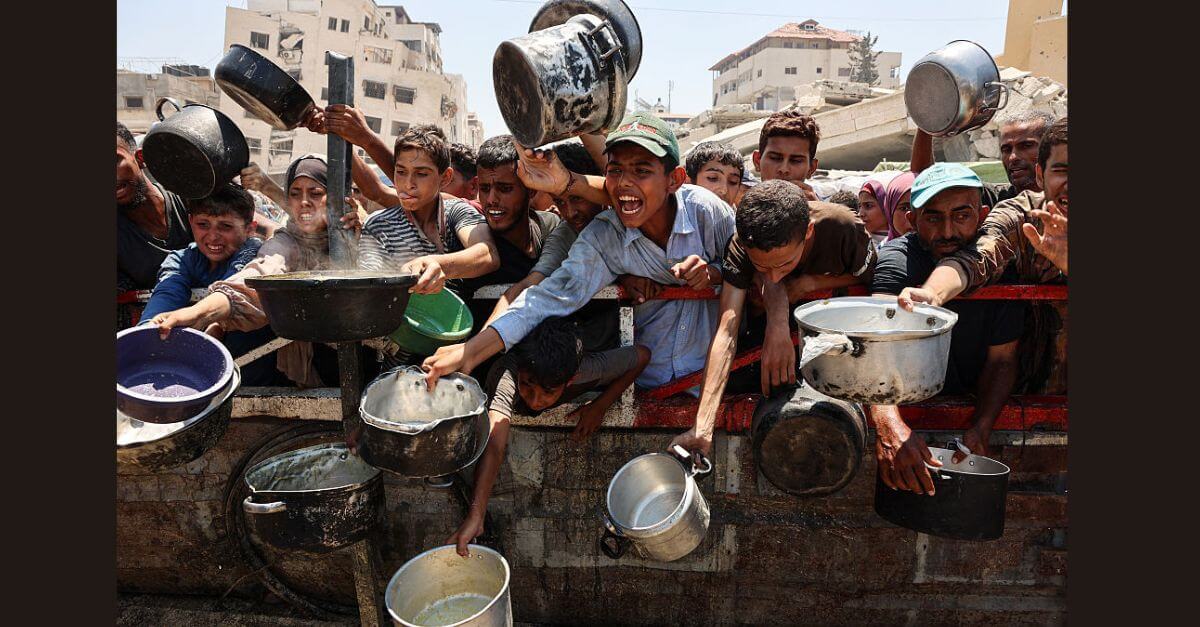 Palestinians crowd at a lentil soup distribution point in Gaza City.