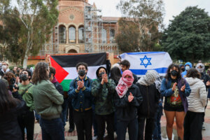 Pro-Palestinian  protesters attempt to block a counter-protester with an Israeli flag at UCLA in March.