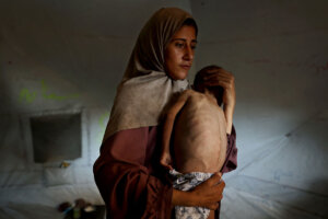 The photo that appeared in the New York Times article, "Gazans are Dying of Starvation." Hidaya, a 31-year-old Palestinian mother, carries her 18-month-old son Mohammed al-Mutawaq.