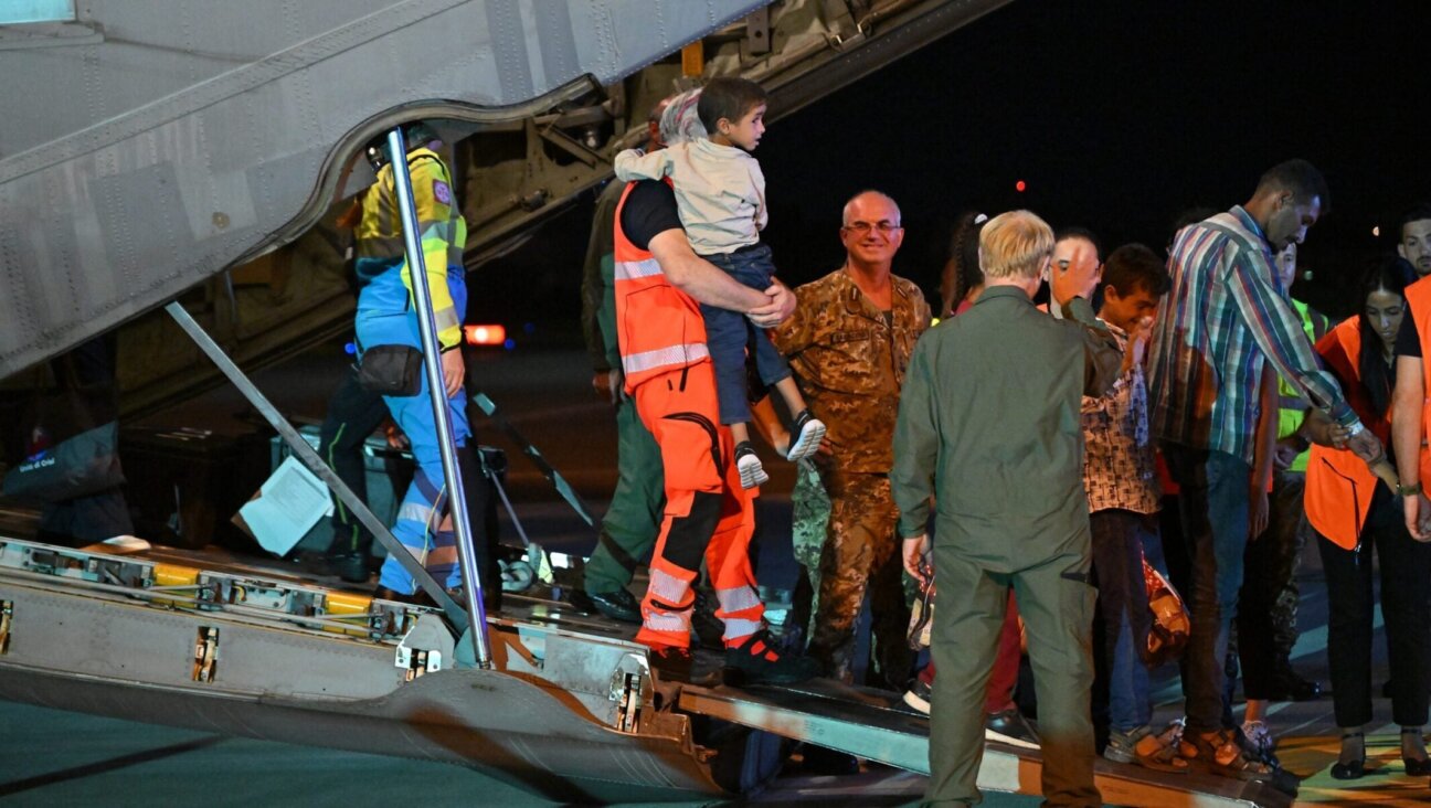 Medics and health personnel welcome Palestinian children from Gaza and their families, after an Italian military plane from Israel landed in Rome in the largest medical evacuation operation since January 2024, on Aug. 14, 2025.