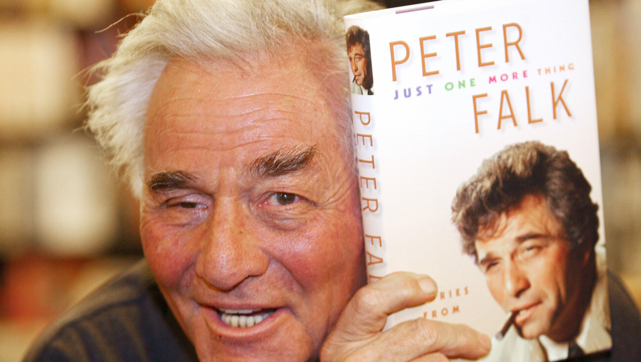 Peter Falk poses with his memoir, which was, naturally, titled <i>Just One More Thing.</i>
