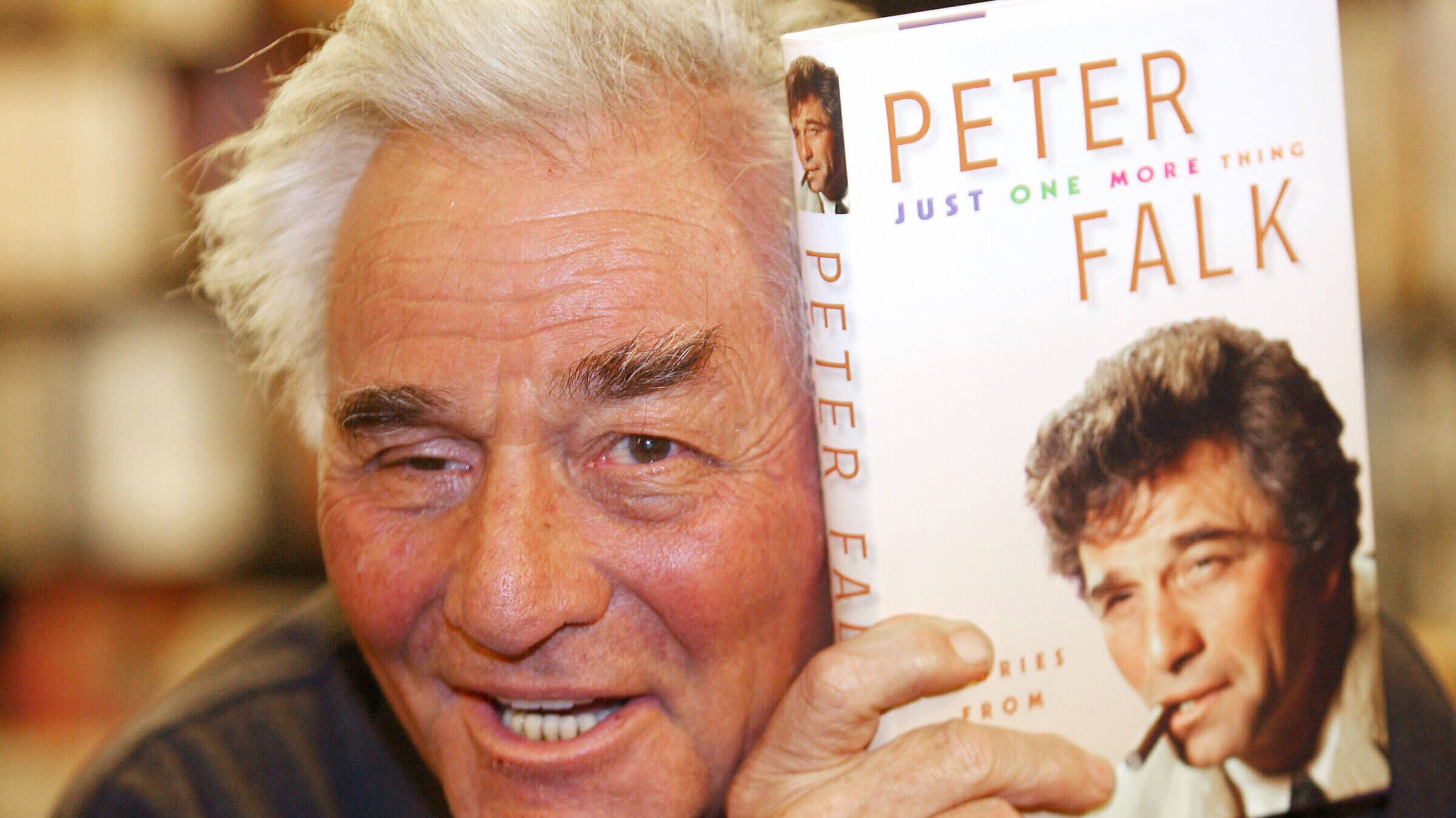 Peter Falk poses with his memoir, which was, naturally, titled <i>Just One More Thing.</i>