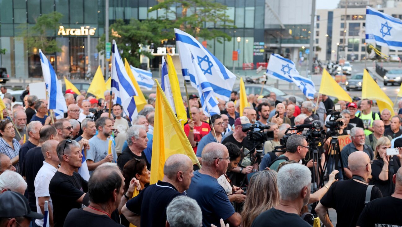 Retired and reserve Israeli Air Force pilots attend a rally calling for an immediate end to the war and urgent action to repatriate the hostages captive in Gaza since October 2023, on August 12, 2025, outside the Israeli Army headquarters in Tel Aviv.