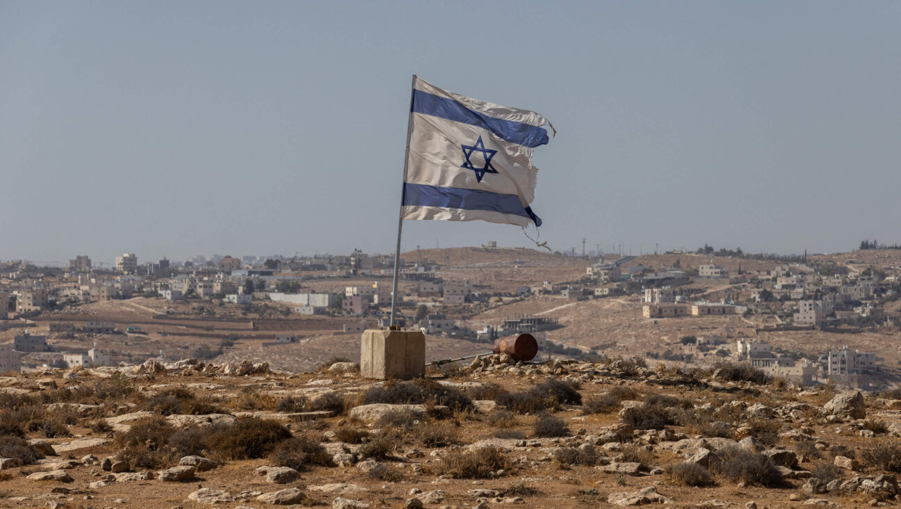 An Israeli flag flies along a highway near the settlement of Carmel in the South Hebron Hills of the West Bank on Aug. 4. 