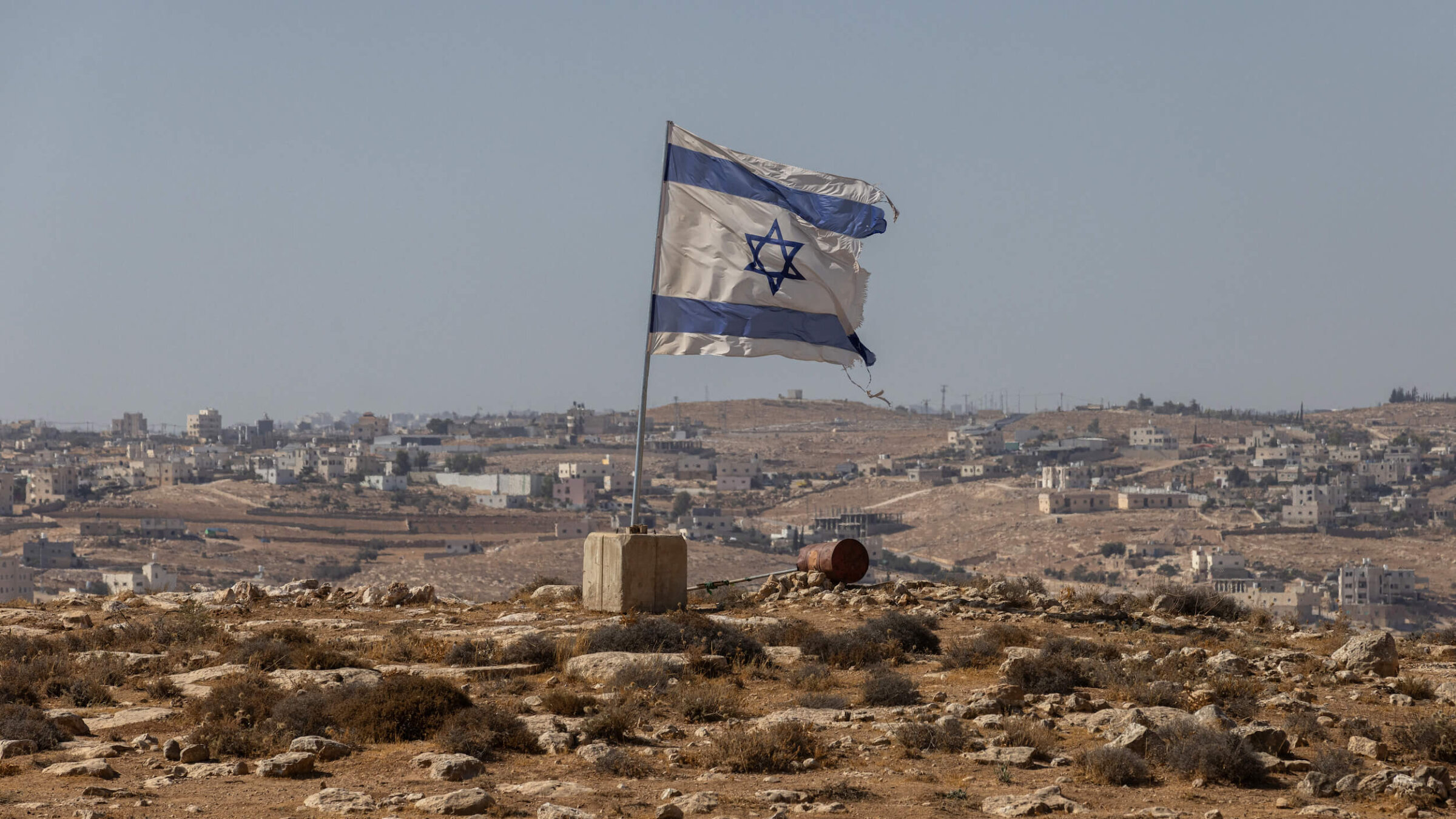 An Israeli flag flies along a highway near the settlement of Carmel in the South Hebron Hills of the West Bank on Aug. 4.