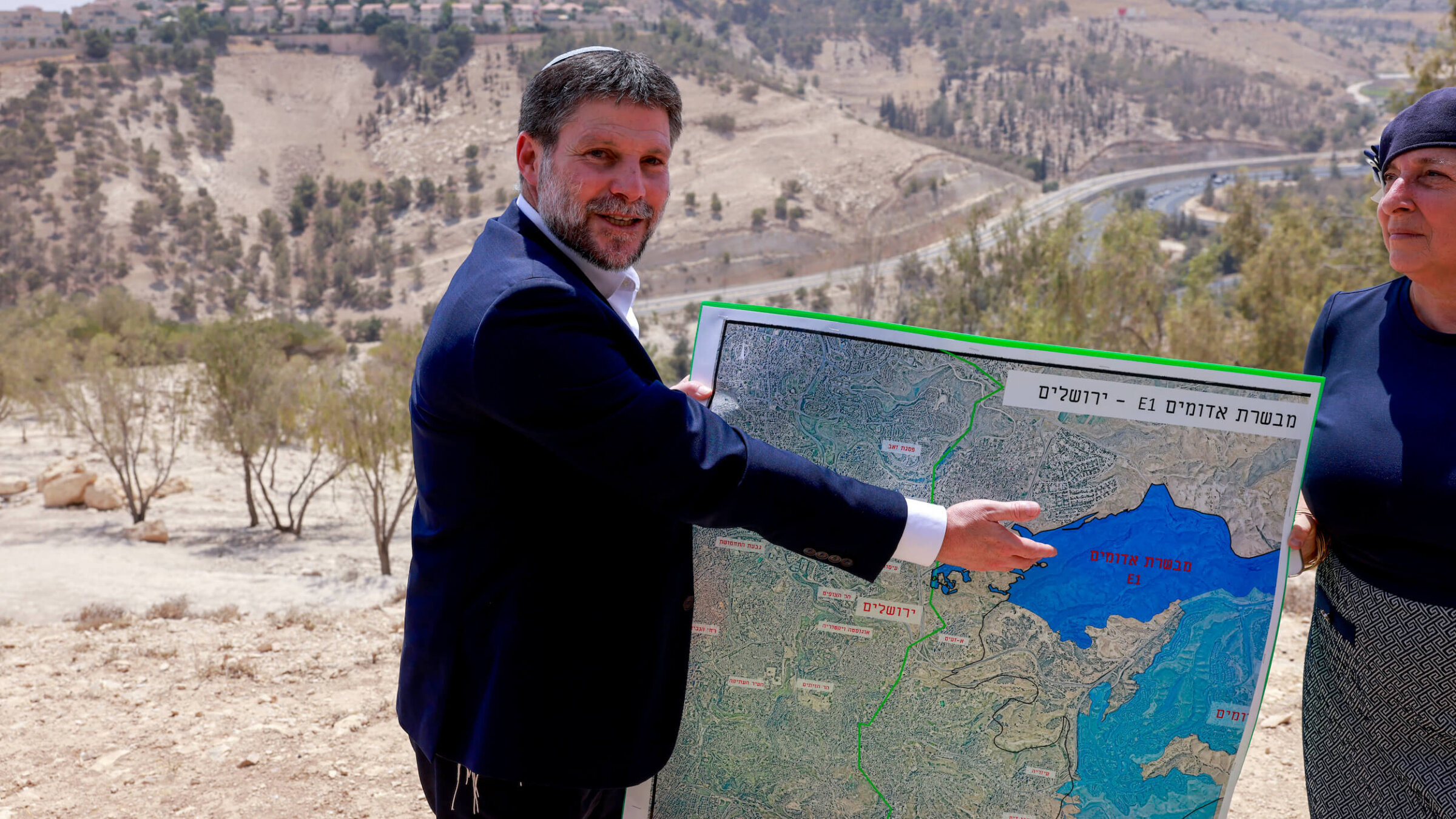 Bezalel Smotrich, Israel's far-right finance minister, displays a map of the West Bank land corridor known as E1, where plans for a new settlement have just been approved, on Aug. 14.