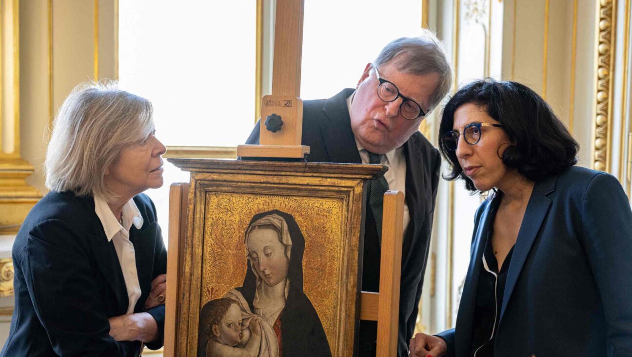 French Culture Minister Rima Abdul-Malak (R) poses next to Felix de Marez Oyens (C) and his wife Theodora de Marez Oyens, representing the heirs of Ernst and Agathe Saulmann and Harry Fuld junior, during a ceremony for the restitution of three works of art looted from German Jews by the Nazis between 1933 and 1945, in Paris, on April 18, 2023.