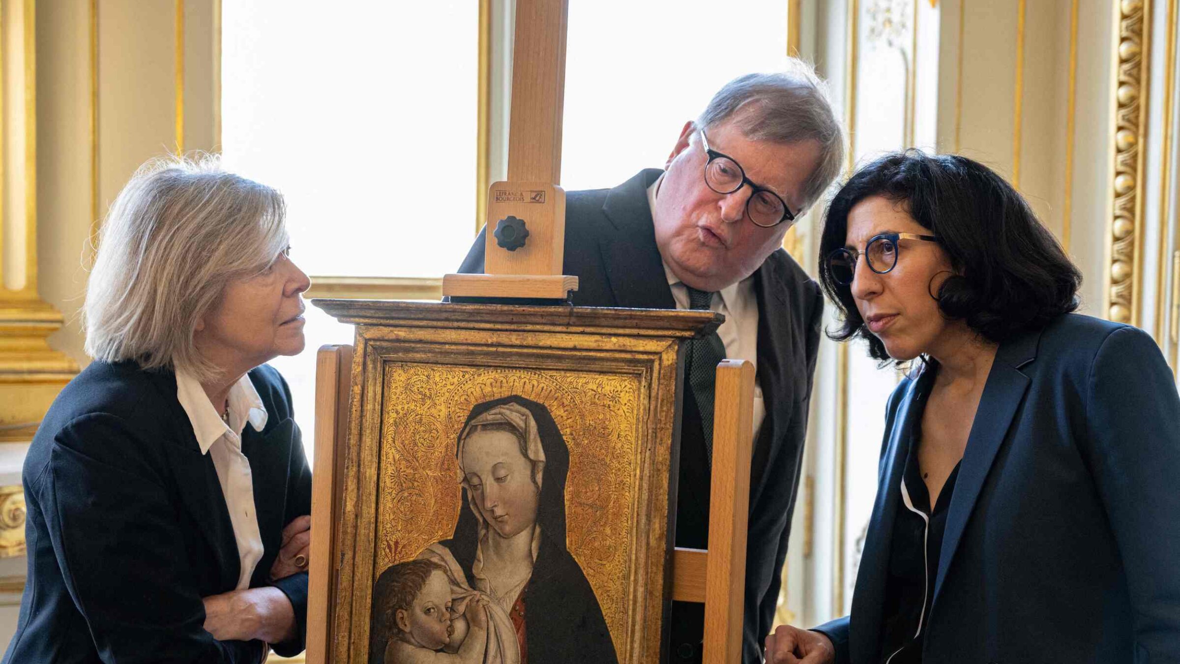French Culture Minister Rima Abdul-Malak (R) poses next to Felix de Marez Oyens (C) and his wife Theodora de Marez Oyens, representing the heirs of Ernst and Agathe Saulmann and Harry Fuld junior, during a ceremony for the restitution of three works of art looted from German Jews by the Nazis between 1933 and 1945, in Paris, on April 18, 2023.