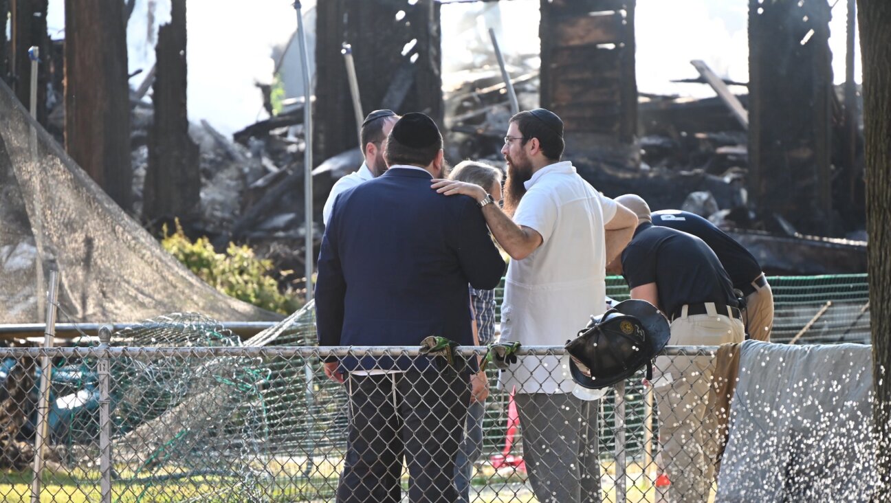 Rabbi Yitzchok Lerman, who survived with his family in the fire that completely destroyed Congregation Beth El synagogue, stands in front of the synagogue’s ruins in Rutherford, New Jersey on August 8.