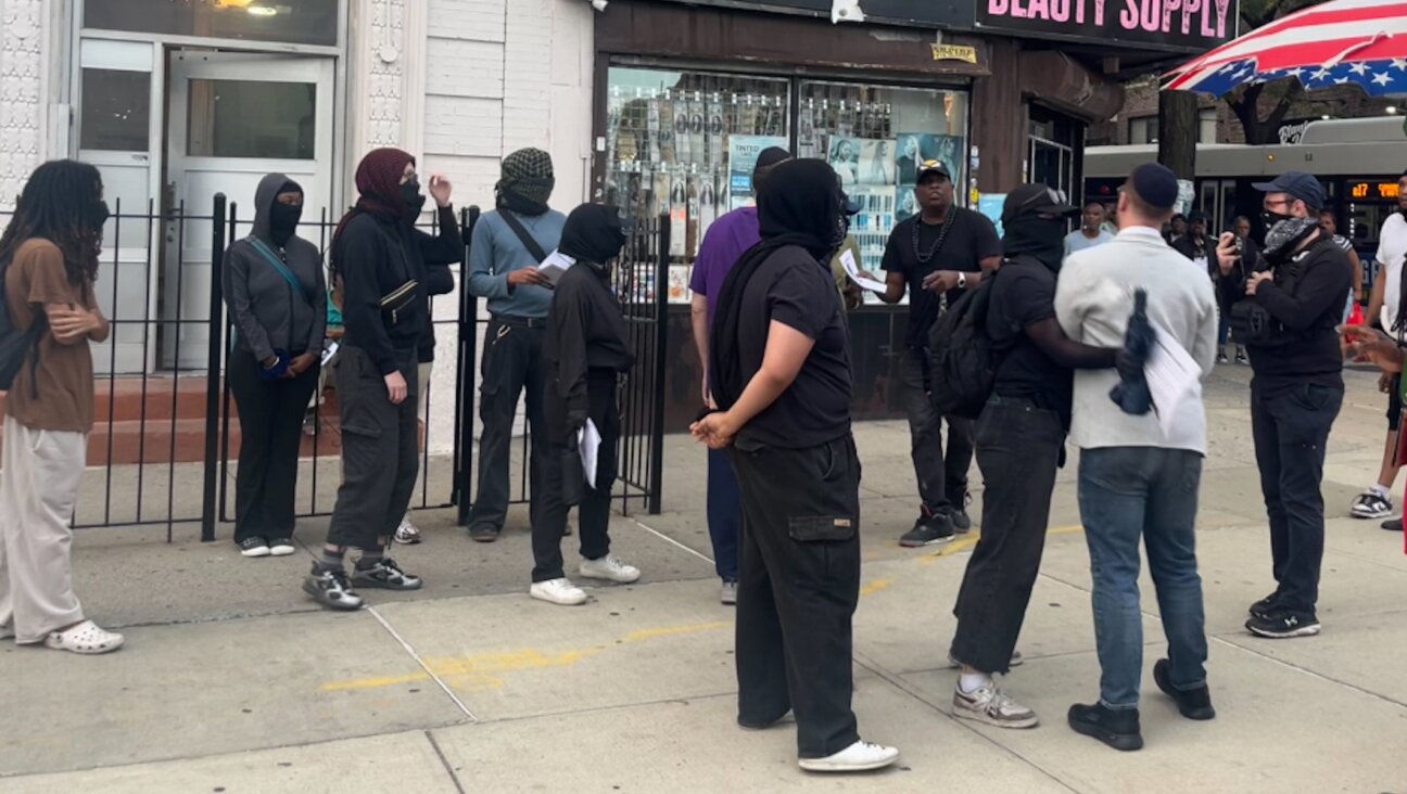 Crown Heights Bites Back members shoved a Jewish man that attempted to approach their vigil for Gavin Cato on August 19, 2025.