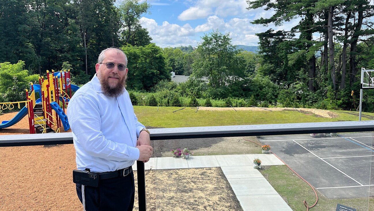 Rabbi Levi Volovik stands on the back porch of the new Chabad of the Berkshires in Lenox, Massachusetts, which includes views of the Berkshire Hills. 