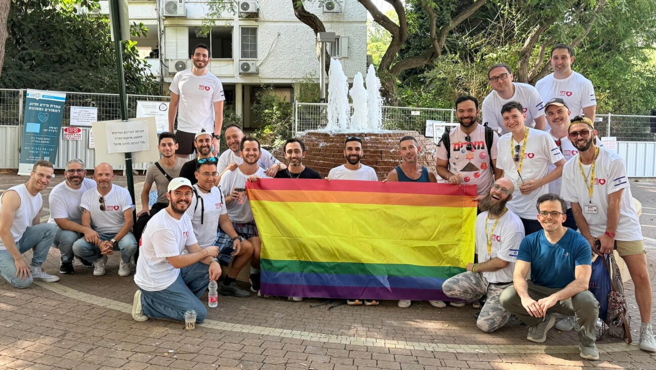 A group from a delegation organized by Hebro and Birthright Israel pose after clearing out an apartment damaged by an Iranian ballistic missile in Ramat Aviv, Israel, in August 2025. 