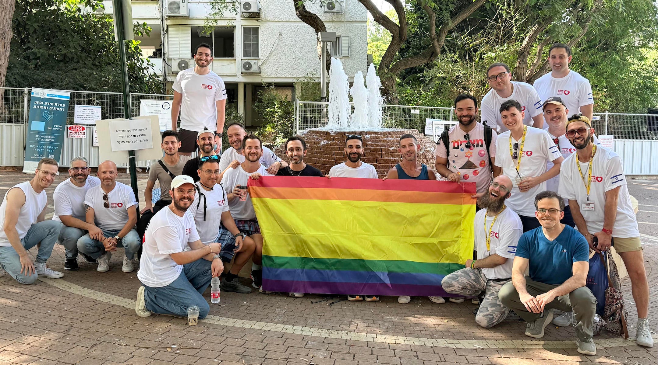 A group from a delegation organized by Hebro and Birthright Israel pose after clearing out an apartment damaged by an Iranian ballistic missile in Ramat Aviv, Israel, in August 2025.